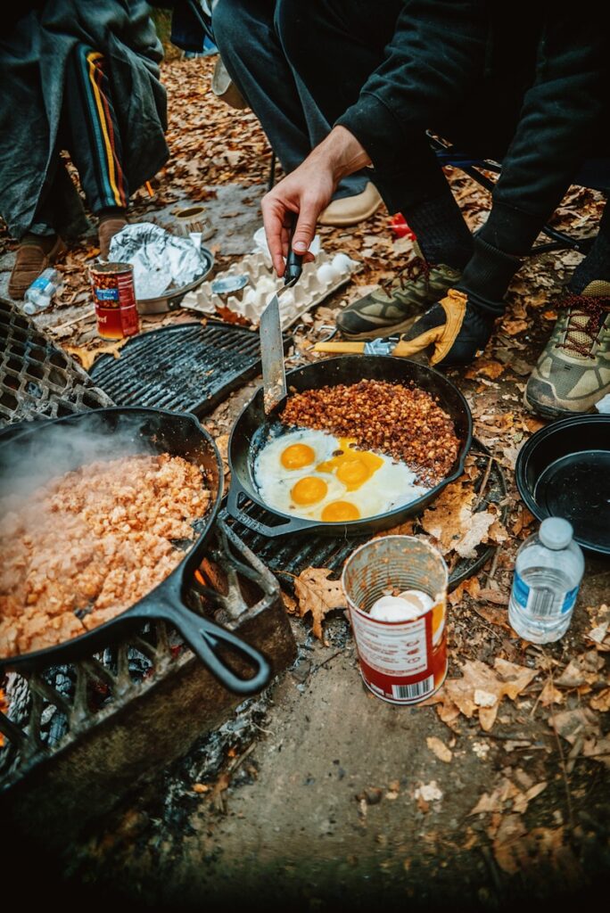 a person is cooking food on a grill